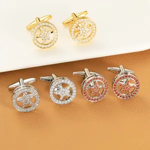Detailed comparison of gold and silver star cufflinks with pavé-set crystals on leather