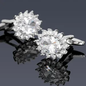Macro shot of silver sunflower cufflinks featuring large oval center stones and small diamonds