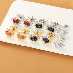 Detail of luxury oval crystal cufflinks with halo diamond setting on leather background