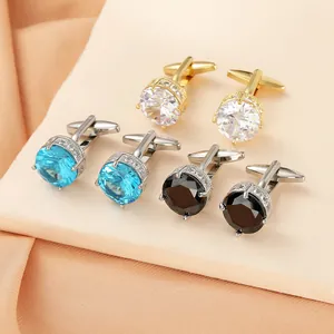 Detailed close-up of gold and silver cufflinks featuring blue, white, and black zircon stones
