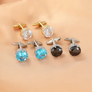 Detailed view of luxury round cufflinks with champagne and blue zircon on silk fabric