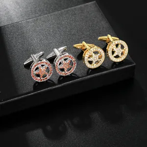 Detailed close-up of gold and silver star cufflinks with inlaid stones on display