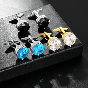 Detailed macro view of round crystal cufflinks in blue, black and white set in silver and gold