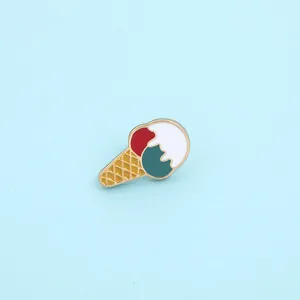 Detail of colorful enamel ice cream cone brooch with red white and green scoops