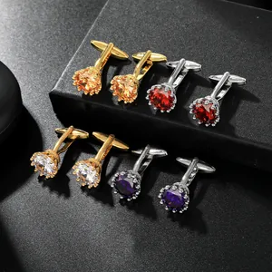 Detalle de gemelos de cristal con engaste de corona en acabados dorado y plateado