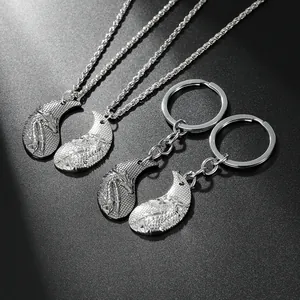Macro shot of silver alloy couple necklaces and keychains with intricate dragon scale relief
