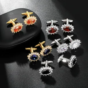 Close-up of luxury oval crystal cufflinks with sparkling zircon border in multiple colors