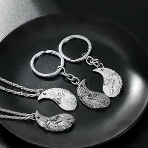 Detail of vintage silver dragon and phoenix Tai Chi pendants on keychains and necklaces
