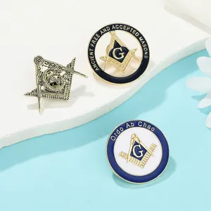Detailed close-up of three Freemasonry lapel pins in bronze, black and blue enamel finishes