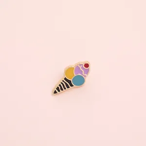 Detailed view of enamel ice cream cone brooch with colorful scoops and golden metal base