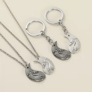 Detailed view of complementary dragon puzzle necklaces and matching keychains in alloy