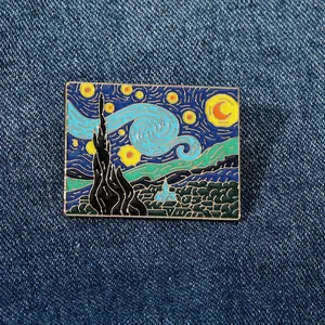 Detail shot of rectangular Van Gogh Starry Night enamel pin on blue denim fabric