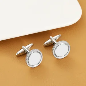 Macro view of silver cufflink showing white enamel center and braided textured border