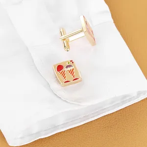 Elegant gold metal cufflinks featuring colorful enamel ice cream cones on a white shirt cuff
