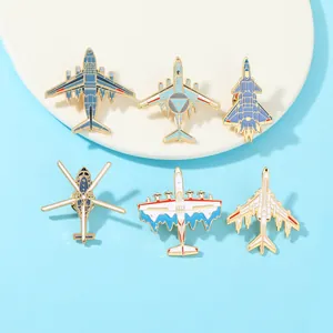 Detail of six aviation enamel pins featuring fighter jets and aircraft on a blue background