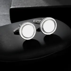 Macro shot of silver round cufflinks featuring knurled edges and polished mirror center