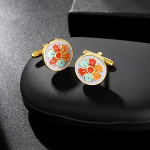 Detailed macro shot of vintage floral enamel cufflinks with elegant gold finish