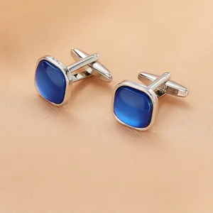 Detailed macro view of square blue crystal cufflinks with polished silver metal finish