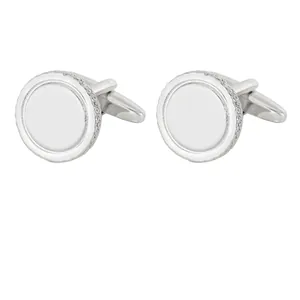 Pair of minimalist round silver cufflinks with knurled edge design and polished center surface