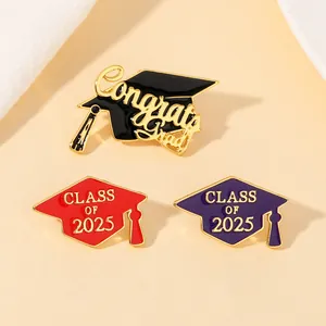 Detailed view of graduation cap pins featuring Congrats Grad and Class of 2025 enamel designs