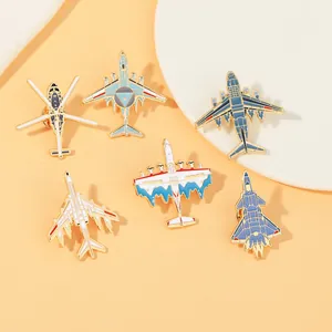 Detail view of six aircraft enamel pins including fighter jets on orange background