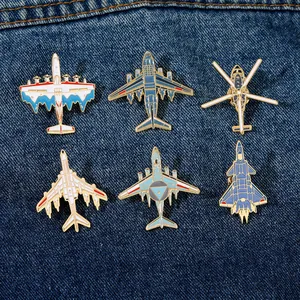 Set of six colorful aviation aircraft enamel pins displayed on dark blue denim fabric