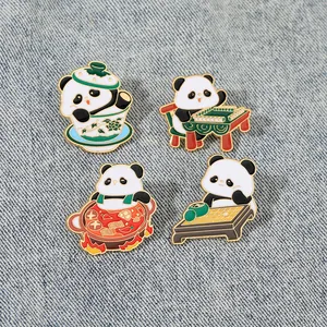 Set of four panda enamel pins featuring tea, mahjong, hotpot and go on denim fabric