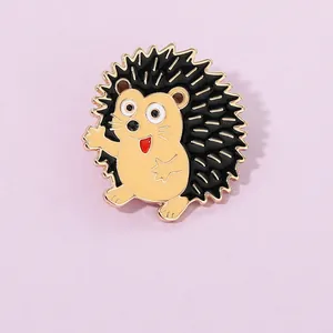 Detailed macro view of a cute cartoon hedgehog enamel pin with gold plating finish