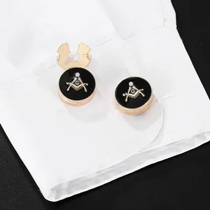 Couvre-boutons franc-maçon dorés avec émail noir sur une manchette de chemise