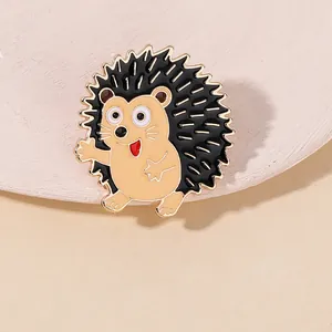 Detail of cute hedgehog enamel pin with gold plating and vibrant cartoon design