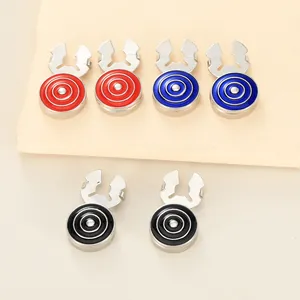 Close-up of geometric cufflinks with colorful enamel inlay in red blue and black