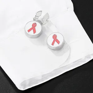 Silver cufflinks with pink ribbon enamel on white shirt sleeve for breast cancer awareness