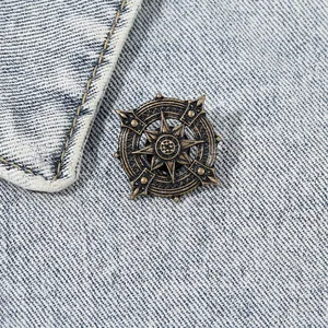 Vintage bronze nautical star lapel pin on blue denim fabric for men and women
