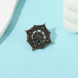 Detailed macro view of vintage bronze anchor lapel pin with antique star gear design