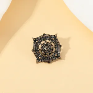 Macro shot of bronze vintage compass brooch with gothic star pattern and antique finish