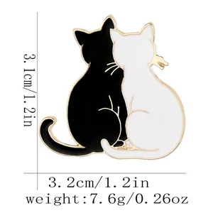 Zinc alloy black and white cat brooch with gold edges and heart shape design 3.1x3.2cm