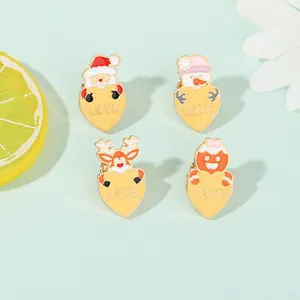 Detailed view of four Christmas enamel pins featuring Santa, snowman, and reindeer motifs