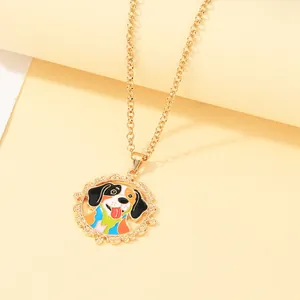 Macro shot of gold-plated alloy pendant with colorful enamel cartoon dog on chain