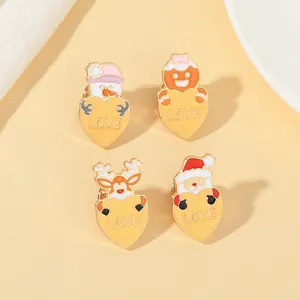 Detailed view of enamel Christmas brooches featuring snowman and reindeer holding love hearts