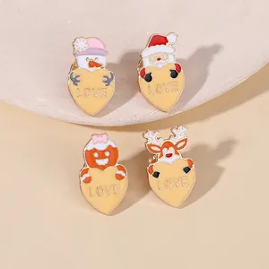 Detail of four Christmas enamel pins featuring snowman and Santa with LOVE hearts