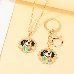 Detail of cartoon dog enamel pendant set with golden necklace and keychain