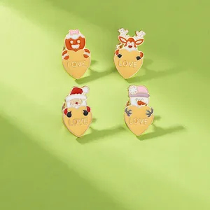Set of four Christmas enamel pins featuring festive reindeer and Santa with love hearts
