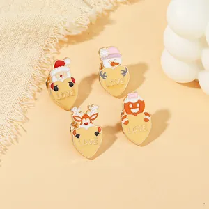 Close-up of colorful Christmas enamel brooches featuring Santa, Snowman, and Reindeer designs