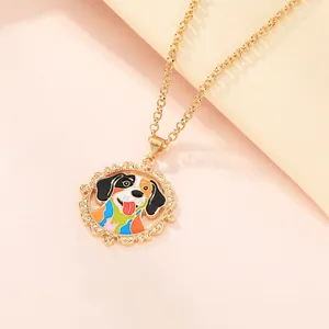 Macro shot of gold-plated necklace featuring a colorful enamel dog pendant and filigree border