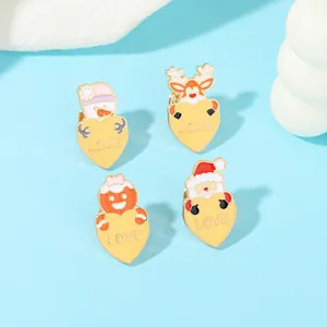 Set of four Christmas enamel pins featuring snowman and reindeer with love hearts