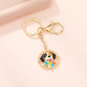 Detailed close-up of a colorful enamel dog pendant on a golden keychain with filigree edge