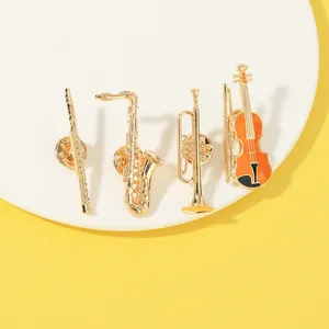 Vintage musical instrument brooch set including saxophone, trumpet and violin pins