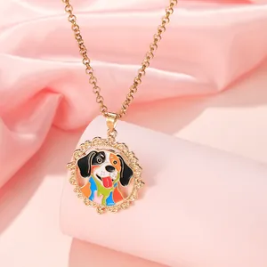 Detailed view of colorful dog pendant necklace on pink silk fabric with gold hollow patterns