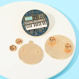 Creative synthesizer enamel pin with blue round design and gold metal butterfly clasp