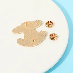 Golden enamel pin back view with double butterfly clutches and frosted metal texture